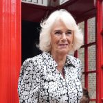 Queen Camilla has everybody in stitches as she bundles into telephone field with schoolchildren – video
